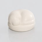 Satin white porcelain ceramic urn sculpture of a sleeping dog