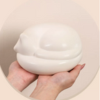 Satin white porcelain ceramic urn sculpture of a sleeping cat 