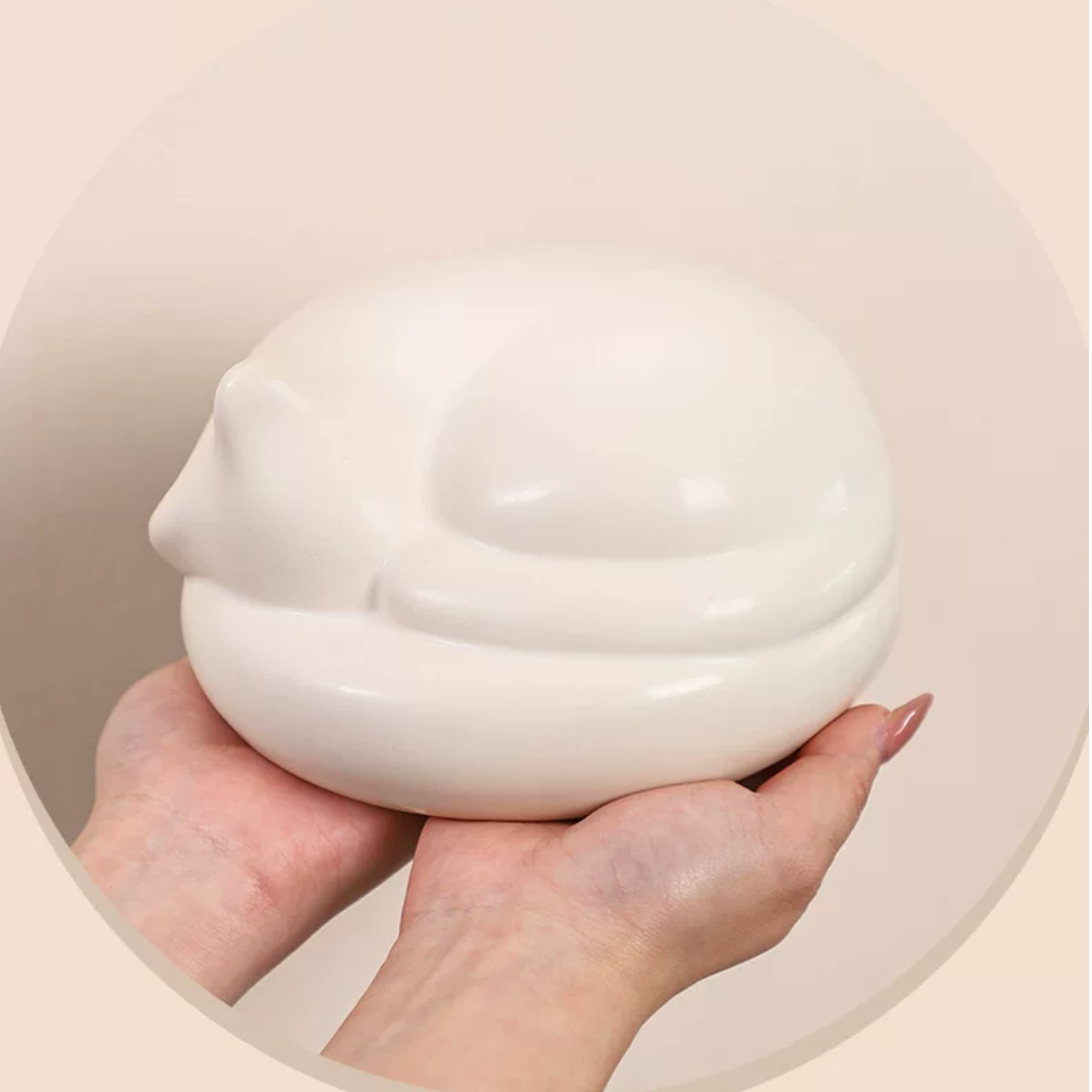 Satin white porcelain ceramic urn sculpture of a sleeping cat 