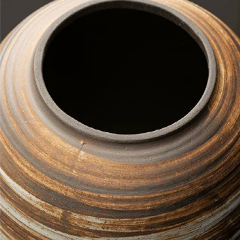 Zoom top view of large rustic earth-colored striped round stoneware pet urn