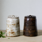 White and brown earth-colored artisanal stoneware pet urns with organic shape and texture