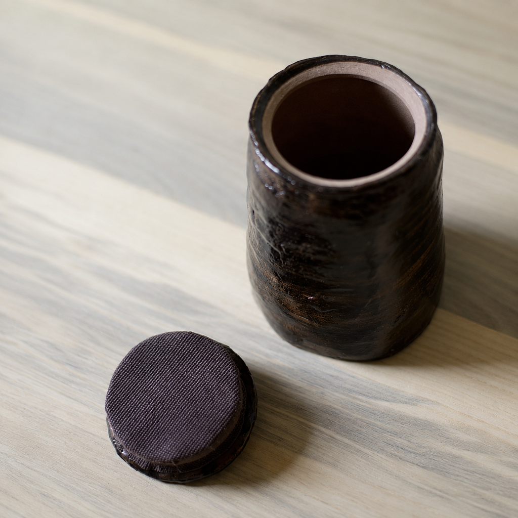 Glazed brown-bronze-black artisanal pet urn with open lid
