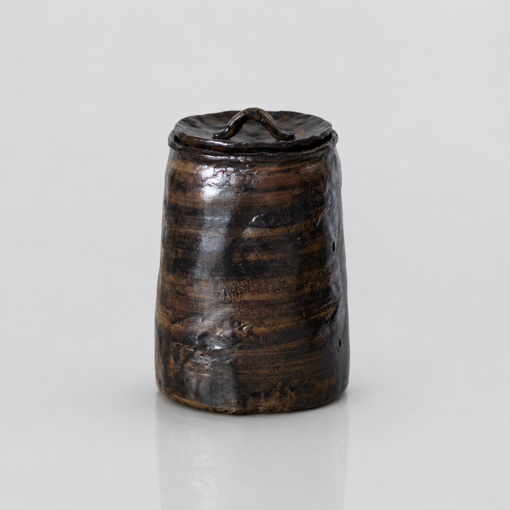 Glazed brown-bronze-black artisanal pet urn with organic shape and color patterns
