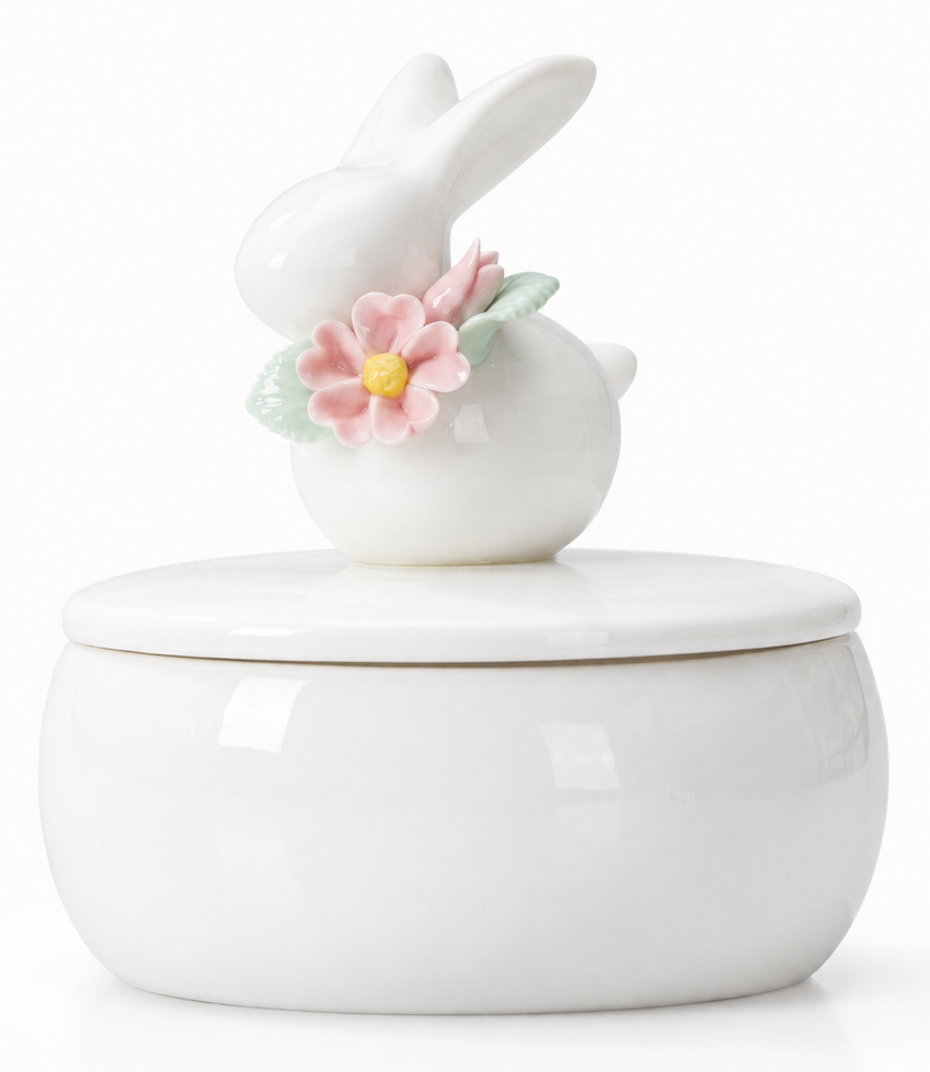 White ceramic jar with bunny and flower lid on a white background